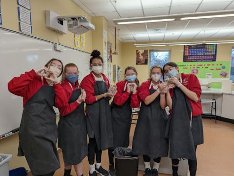 Sophomores holding their sheep hearts after the dissection. 