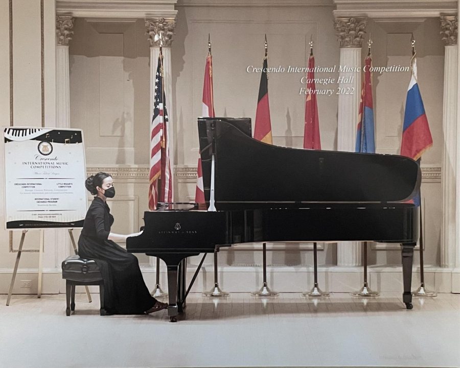 Trisha Tran 23 performs a piano piece at Carnegie Hall. 