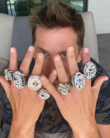 No, he’s not done just yet! Tom Brady poses with his seven Super Bowl rings.