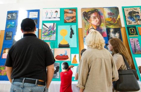 Visitors admire the artwork at the 2022 Student Arts Showcase. 