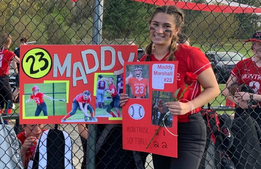 Maddy Marshall poses with the sign made by her teammates to celebrate her at the senior game. 