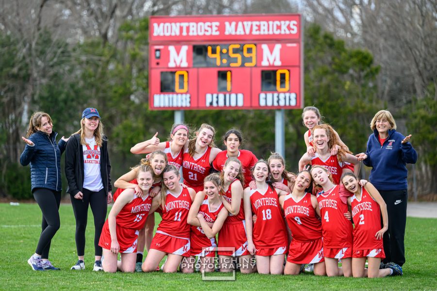 The+lacrosse+team+poses+for+a+photo+on+Miracle+Field.+