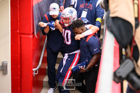 Mac Jones is helped off of the field after injuring his ankle on the final play of the New England Patriots home opener against the Baltimore Ravens. 