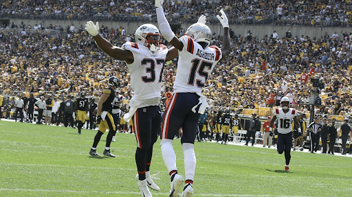 New England Patriots Damien Harris and Nelson Agholor celebrate in the end zone during their team’s 17-14 road-game win over the Pittsburgh Steelers 