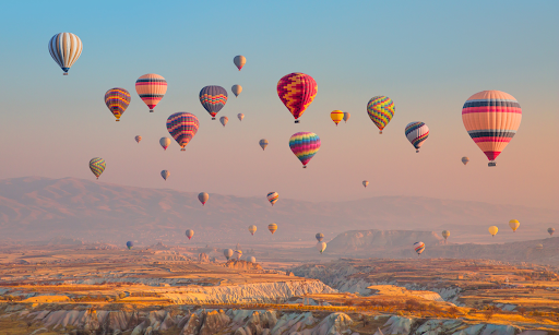 A photo of hot air balloons, which work because hot air rises.