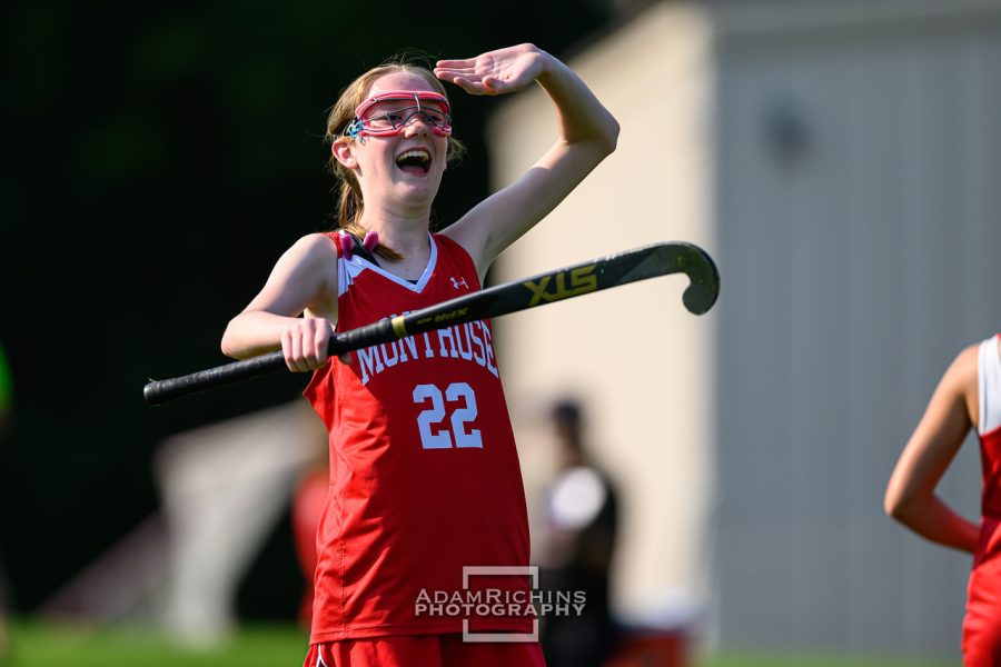 Bridget Devaney 27, one of the three middle schoolers on Varsity Field Hockey, celebrates after making a good play.