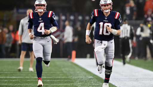 New England Patriots quarterbacks Bailey Zappe (left) and Mac Jones (right) warm up for their Monday night faceoff against the Chicago Bears at Gillette Stadium (Foxboro, MA) 