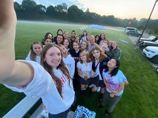 The Montrose class of 2024 takes a 0.5x selfie together during senior sunrise on Miracle Field.