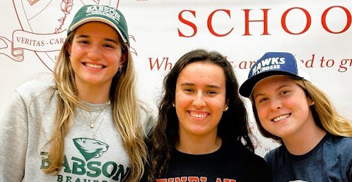 (left to right) Kenzie Cassler (Babson College), Vivian Krawiecki (University of Findlay), and Shannon Mahoney (St. Anselm College), pose in their college’s apparel after signing their National Letter of Intent to continue their lacrosse careers.