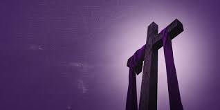 A cross with a purple ribbon symbolizing that it is the Lenten Season