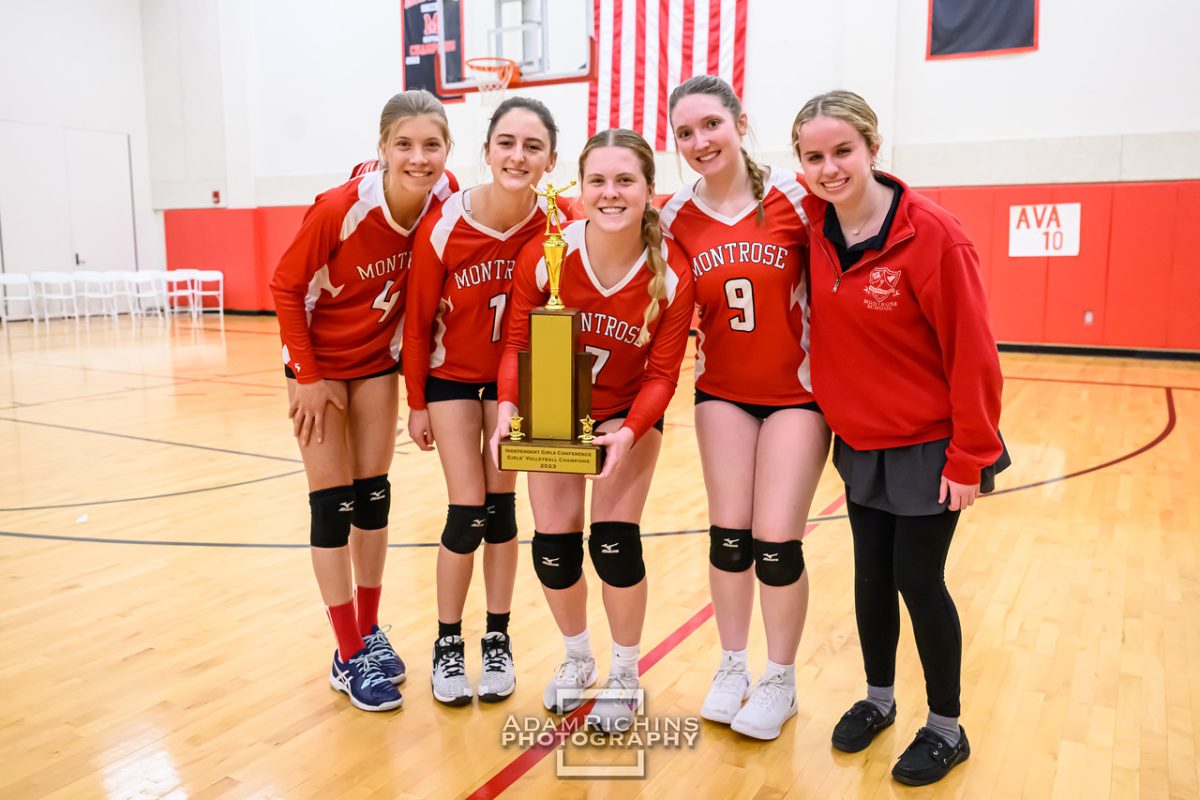 The Varsity Volleyball team’s seniors pose with the IGC Championship trophy.