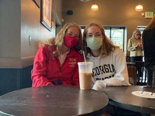 Leslie Baker ‘24 and Anna Hvidsten ‘23 sit in Starbucks with their coffee.