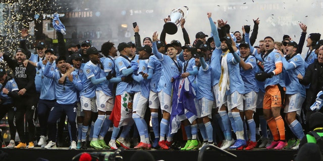 New York City FC players celebrate their penalty kick shootout win over the Portland Timbers in the MLS Cup soccer game. 