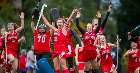 Field Hockey Co-Captain and Co-Sports Editor Mary McManmon 20 jumps for joy with her teammates after a game at McCarthy Field last fall.