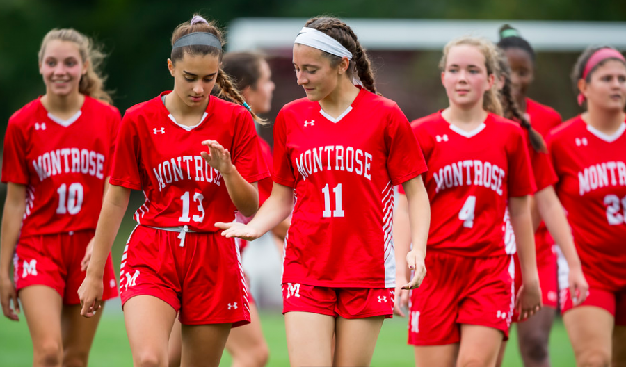 Varsity Soccer Seniors Steph Ciampa 20 (left) and Maria Lennon 20 (center) high five during a game against Gann Academy last fall on Miracle Field.