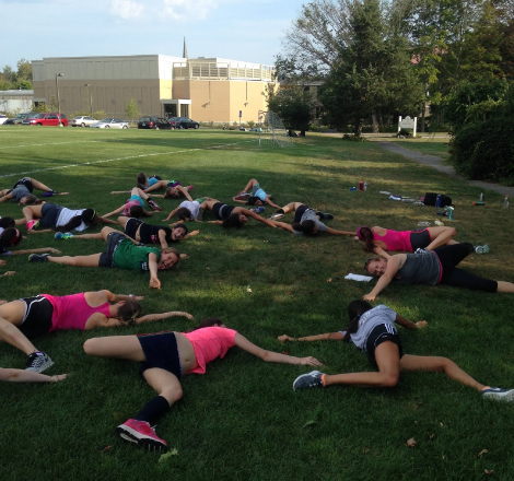Cross-Country team warms up with some yoga before the big meet!