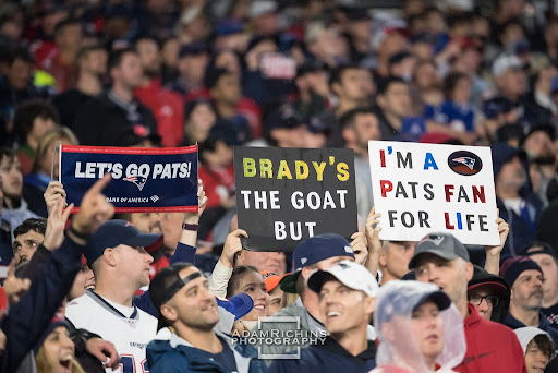 Patriots fans hold up signs at the game on Sunday.