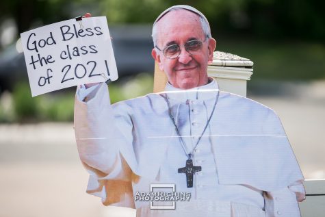 A cardboard cutout of Pope Francis greets the senior class at the Maverick Motorcade.